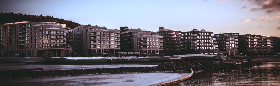 Landscape Photography Of Body Of Water Beside High Rise Building During Golden Hour photo