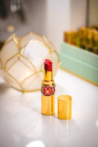 Close-Up Photography Of Red Lipstick On Desk photo