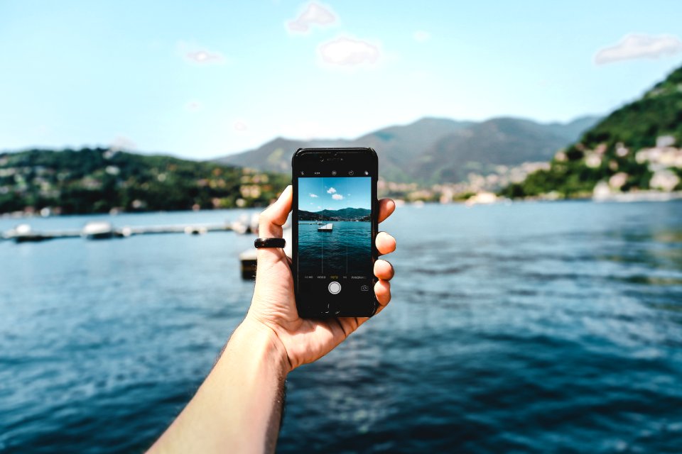 Person Holding Space Gray Iphone 5s Taking Picture Of Beach