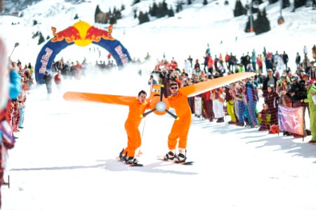 Photography Of Men In Orange Suits Ridding Snowboard photo
