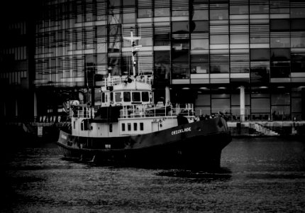 Grayscale Photo Of Ship Near Building