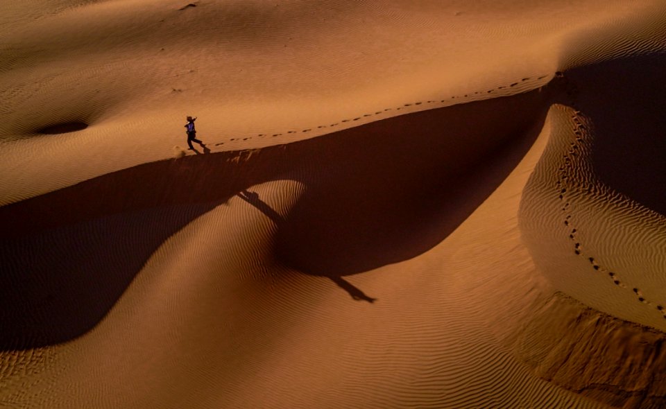 Person Walking On Desert