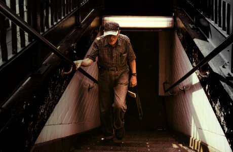 Man In Collared Shirt And Gray Pants Walking On Stairs photo
