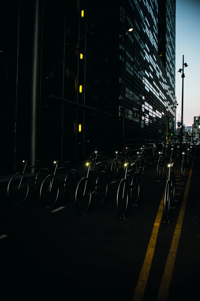 Gray Bike On Road Between Buildings