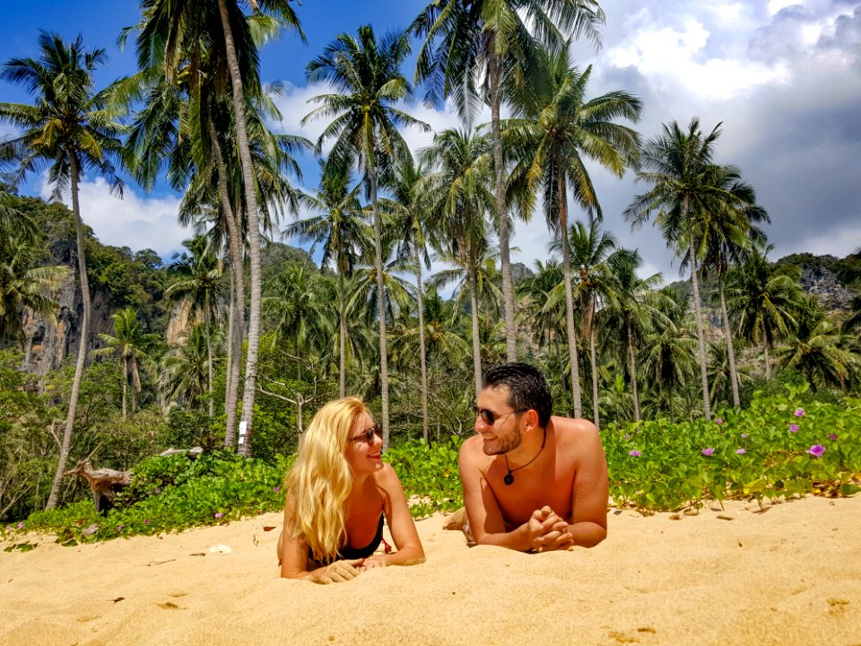Man And Woman Lying On Sand