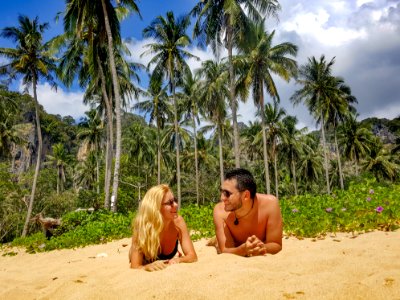 Man And Woman Lying On Sand