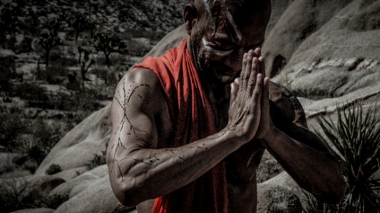 Man Wearing Red Scarf Praying