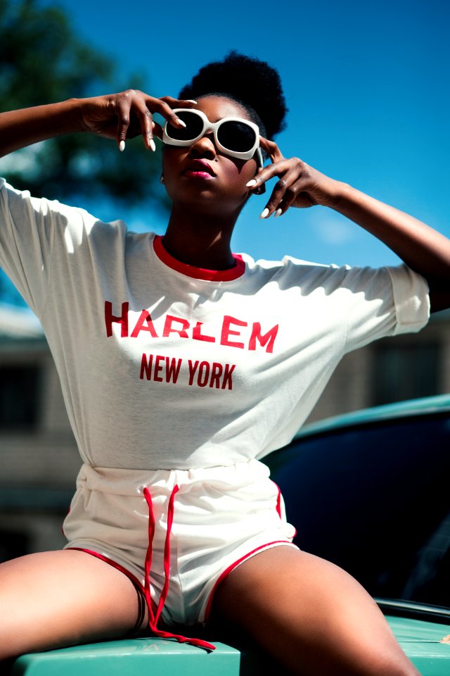 Woman Wearing White And Red Harlem New York Printed Round-neck Batwing-sleeved Shirt With Drawstring Dolphin Shorts
