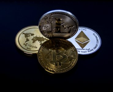 Four Assorted Cryptocurrency Coins photo