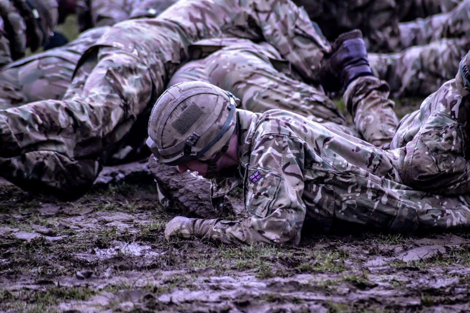 Group Of Soldiers Crawling On Mud