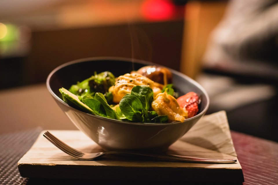 Round Stainless Steel Bowl With Cooked Meat And Vegetables photo