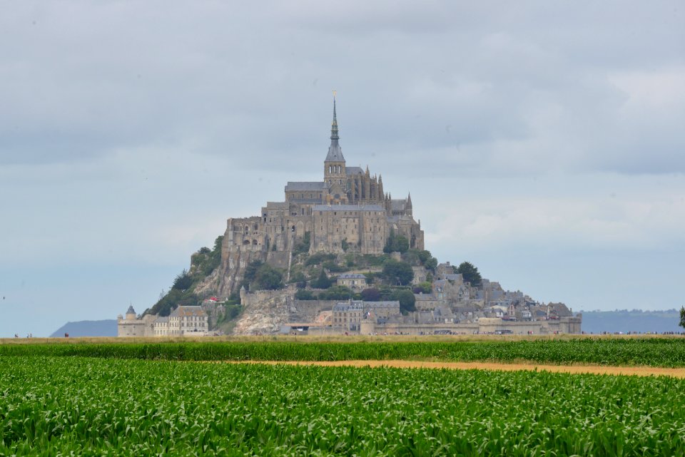 Mont Saint-michel Under White Clouds And Blue Sky photo