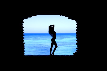Silhouette Of Woman Standing Between Walls photo