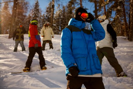 Group Of People In Bubble Jackets Skiing In Mountain