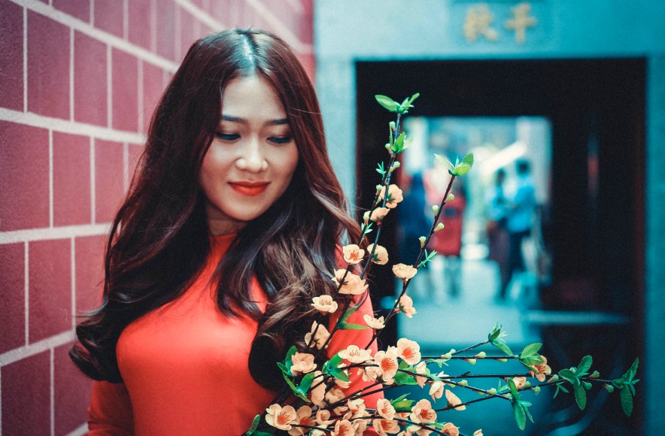 Woman Wearing Red Long-sleeved Shirt In Front Of Flower
