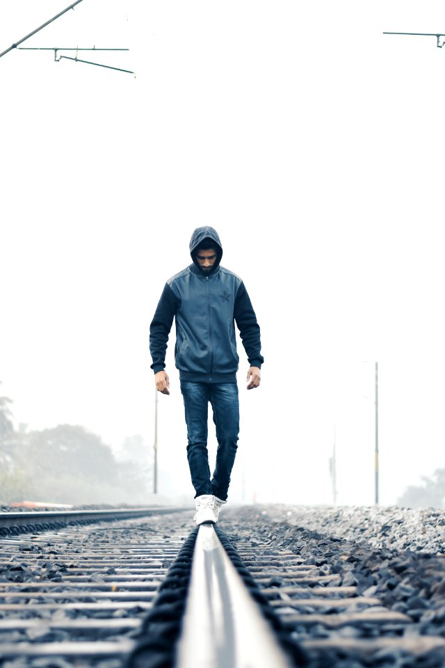 Man Walking On Train Rail