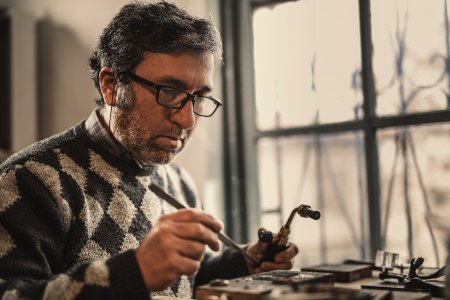 Man In Gray And Black Argyle Sweater Holding Acetylene Torch photo