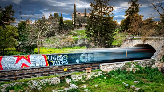 Time Lapse Photography Of Train Passing Through Bridge photo