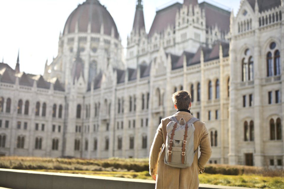 Focus Photography Of Man Looking On White Concrete Building