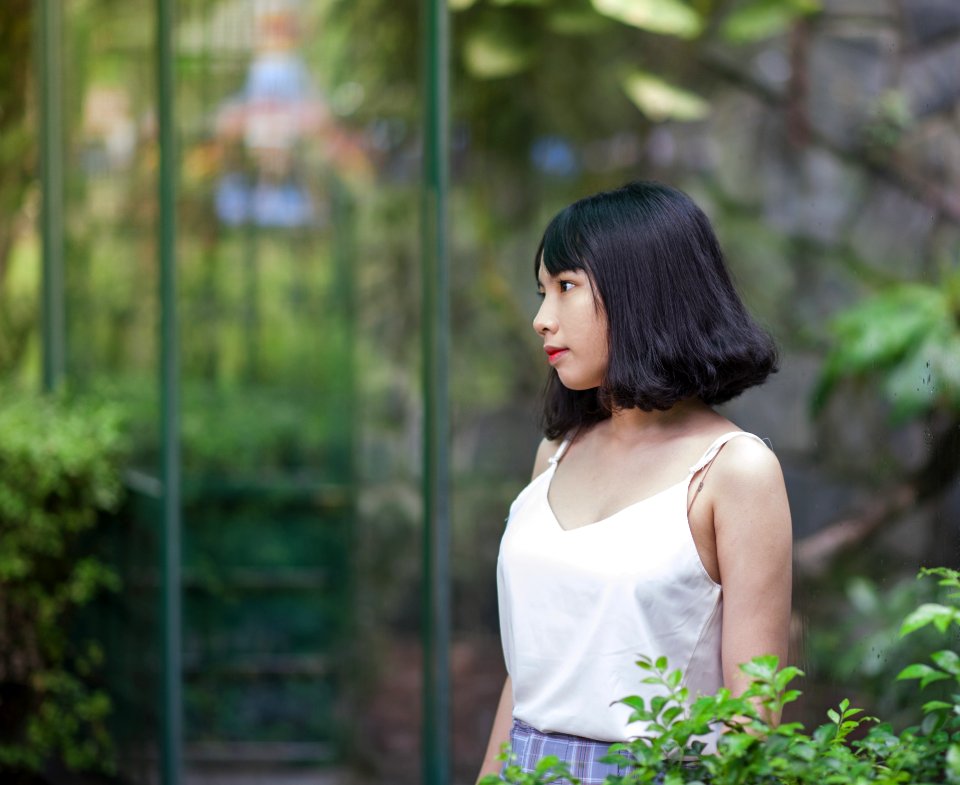 Black Haired Woman In White Spaghetti Strap Top