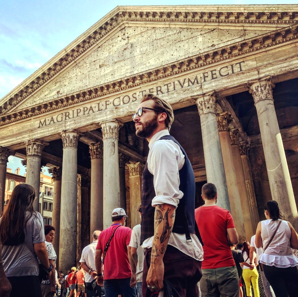 Man In Blue Waistcoat And White Dress Shirt Standing Near Magrippa Lf Costertivm Fecit Temple Behind Crowd Of People