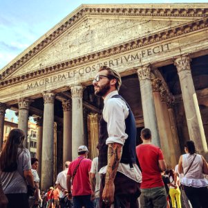 Man In Blue Waistcoat And White Dress Shirt Standing Near Magrippa Lf Costertivm Fecit Temple Behind Crowd Of People