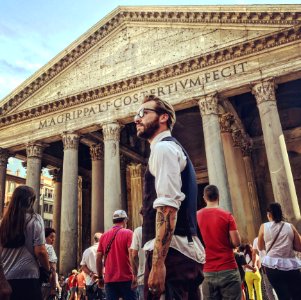 Man In Blue Waistcoat And White Dress Shirt Standing Near Magrippa Lf Costertivm Fecit Temple Behind Crowd Of People photo