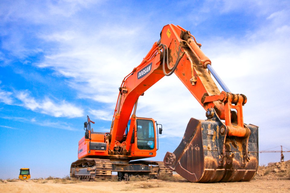 Red Excavator On Dry Field