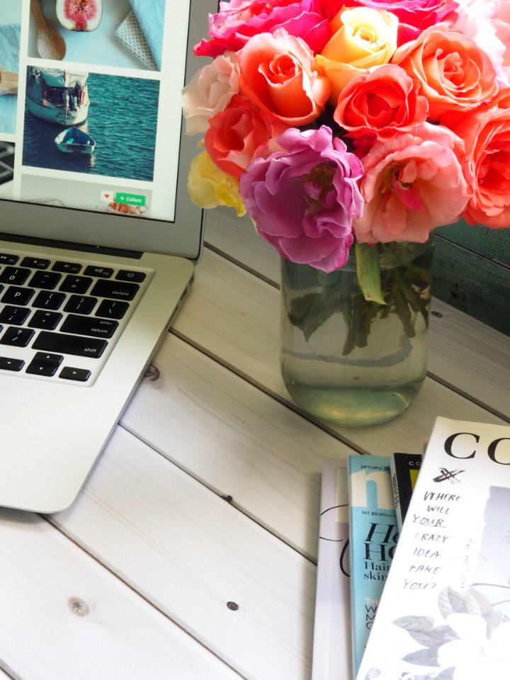 Assorted-color Flower Arrangement In Clear Glass Vase Beside A Laptop