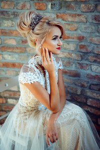 Woman In White Lace Dress Sits On Chair photo