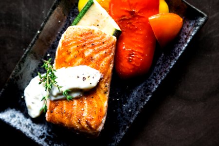 Grilled Salmon Fish On Rectangular Black Ceramic Plate photo