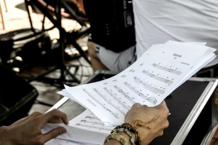Person Holding White Musical Note Sheets photo