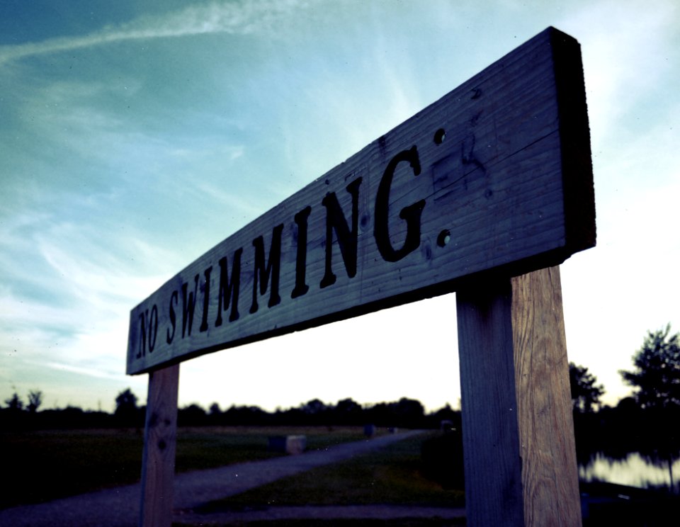 Brown And Black Wooden No Swimming Signage
