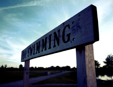 Brown And Black Wooden No Swimming Signage