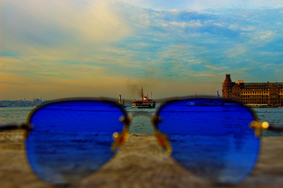 Blue Sunglasses With Black-frame On Concrete Stone