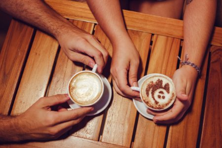 Two People Holding White Cup With Coffee photo