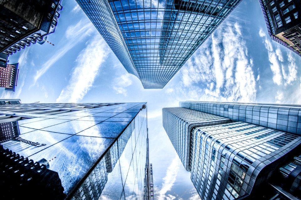 Low-angle Photo Of Four High-rise Curtain Wall Buildings Under White Clouds And Blue Sky