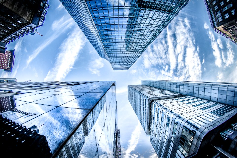 Low-angle Photo Of Four High-rise Curtain Wall Buildings Under White Clouds And Blue Sky photo