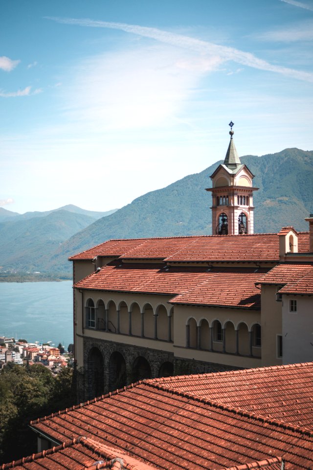 Photography Of Concrete Building Near Mountains photo