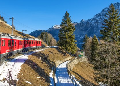 Moving Train With Mountain And Trees In Background