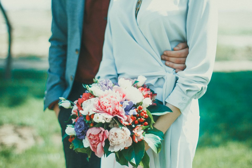 Man And Woman Standing On Grass Field