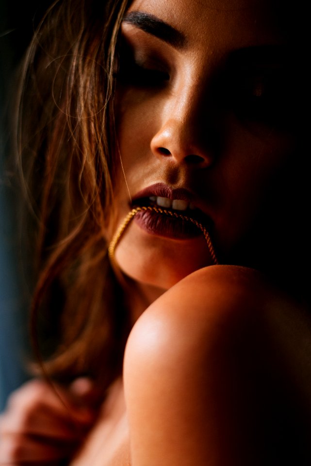 Photo Of Woman Biting Her Necklace