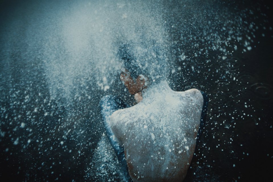 Topless Man Showering With White Powders