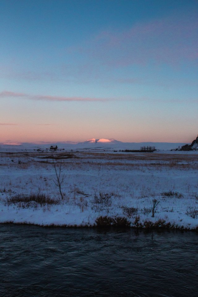 Snow-covered Filed Near Body Of Water photo