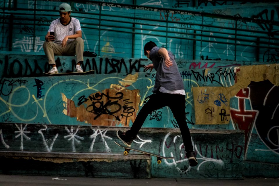 Man Wearing Geay Shirt Playing Skateboard