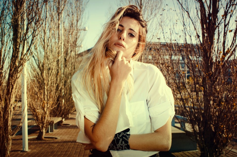 Blonde Woman In White Dress Shirt Beside Brown Plants