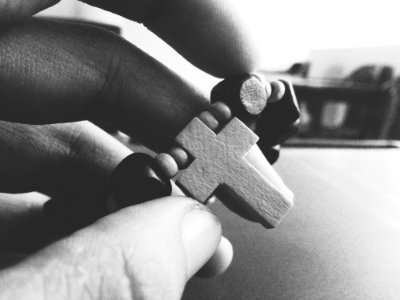 Grayscale Photography Of Person Holding Rosary photo