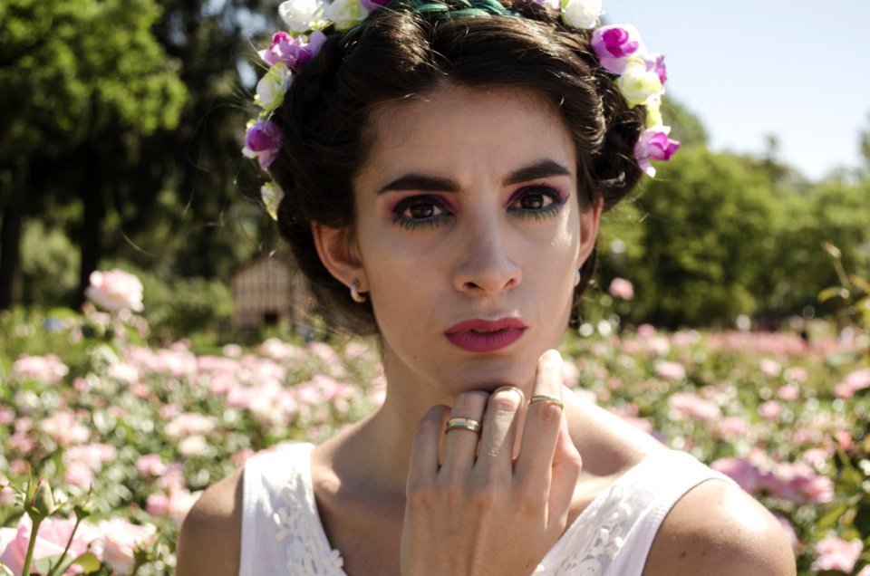 Woman In White Floral Headdress And White Sleeveless Top Behind Pink Flower Field At Daytime