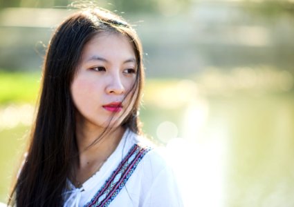 Woman In White Blue And Maroon Top Facing Right photo