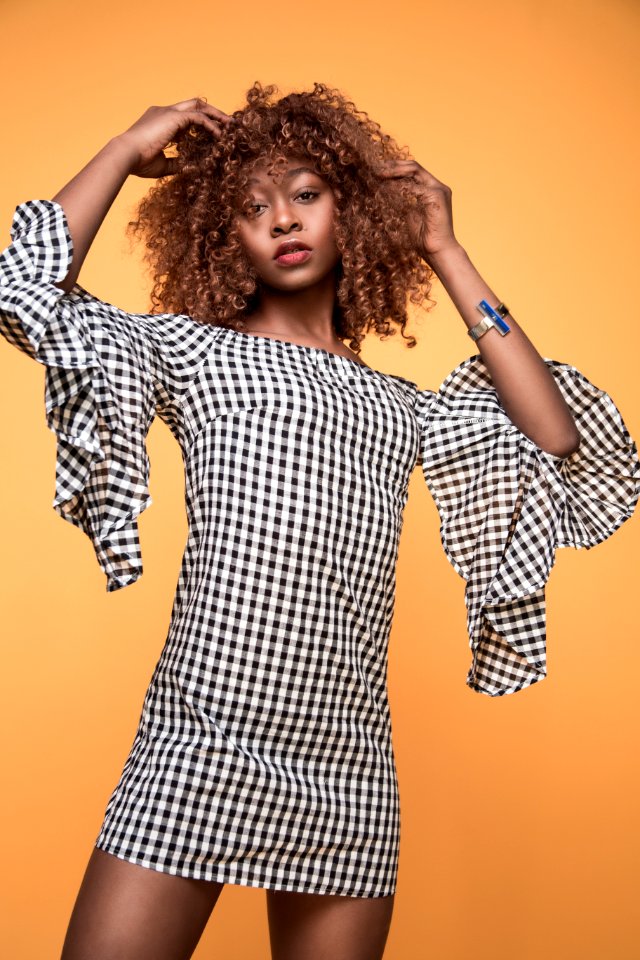 Woman Wearing White And Black Checkered 34 Sleeved Shirt